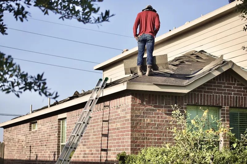 Professional roofer working on a residential roof in Watkins Mill